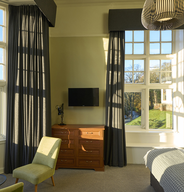 Bedroom with double bed, big windows, and places to sit
